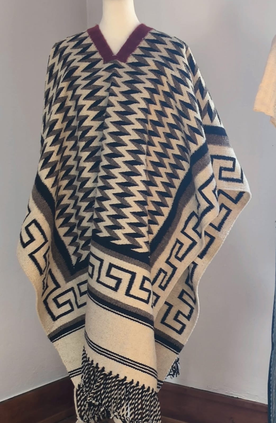 Tlaxcallan - handwoven cream and navy wool poncho with Greek key border by Claudio Netzahualcoyotl Bautista, Indian Market 2026