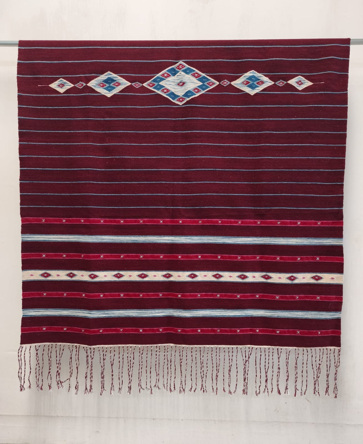 El Tiempo - deep cochineal-red handwoven sarape with diamond medallions and geometric bands by Ignacio Netzahualcoyotl and Marlen Reyes Andrade, Indian Market 2026